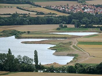 Um die Flächen in der rechten Bildhälfte geht es: Hier will die Firma Sand und Kies abbauen. Links ist ein Baggersee zu sehen, der sich gebildet hat, nachdem dort die beiden Rohstoffe ausgebeutet worden sind. Im Hintergrund liegt die Gemeinde Sand. Im Vordergrund (unten) ist der Main zu erkennen. Unser Archivbild entstand im Sommer.  Foto: Klaus Schmitt
