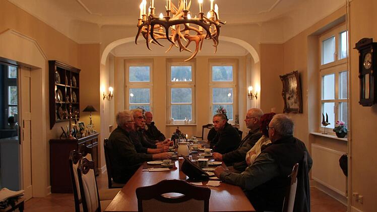 Drinnen im Haus sitzen die Jäger gemütlich an der Kaffeetafel.