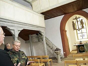 Oberstleutnant Michael Meder erläutert Regionalbischof Christian Schmidt (links) die Geschichte der Bonnland-Kirche. Foto: Arkadius Guzy