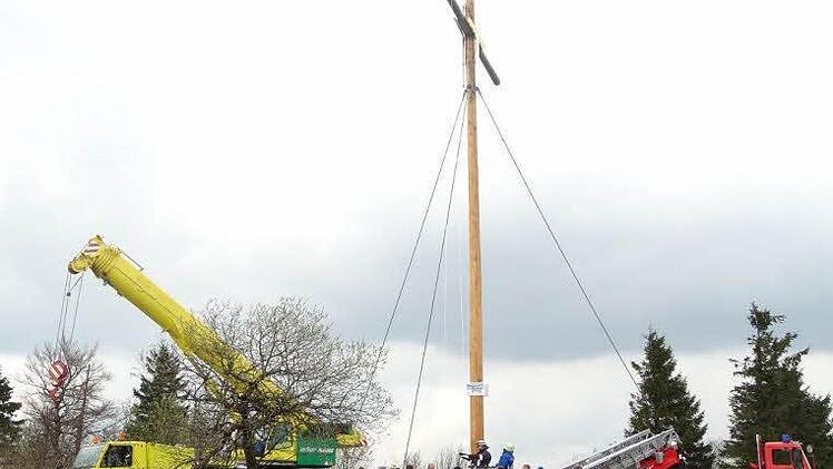 Der Kreuzberg hat sein Gipfelkreuz wieder. Eine Vielzahl Schaulustiger wohnte der Aufstellung des Kreuzes bei. Foto: Marion Eckert