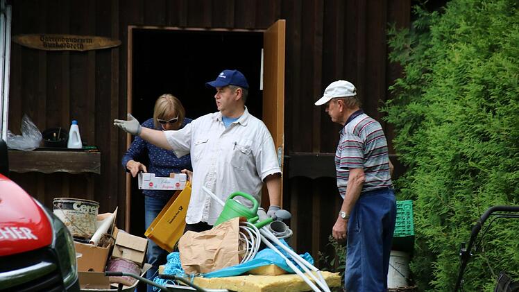 Günter Balling (Mitte), Anita May (rechts) und Wolfgang Rottenberger beim Entrümpeln der vorhandenen Gartenhütte. Foto: Kathrin Kupka-Hahn