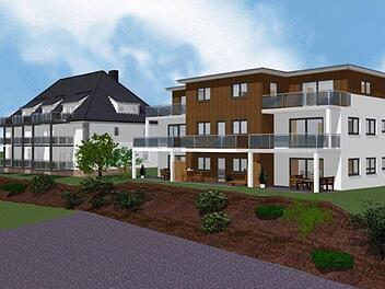 Das neue Wohnprojekt in Burkardroth steht neben der alten Schule am Kirchberg. Rechts zeigt die Visualisierung den geplanten Neubau, links daneben die alte Schule. Foto: Wolf-Haus