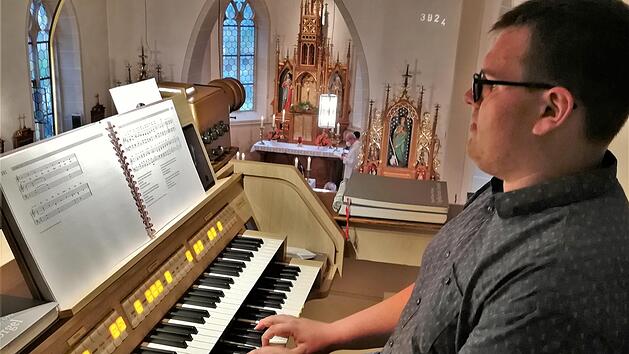 Organist Louis P&ouml;rtner (18) an seiner neuen elektronischen Orgel in der Kleinbracher Kirche