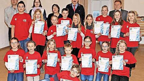 Diese Buben und Mädchen aus den Musikvereinen Poppenlauer und Rannungen haben die Prüfung für das Juniorabzeichen geschafft. Zur Übergabe der Urkunden und Abzeichen kamen auch die Bürgermeister Matthias Klement und Fridolin Zehner (rechts, hinten). Die Prüfung nahmen Thomas Reuss und Bianca Greubel sowie Lydia Summa ab (hinten, von links).  Foto: Dieter Britz