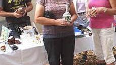 Der Generationenflohmarkt pr&auml;sentierte ein vielf&auml;ltiges Angebot. Renate Holzmann (rechts) aus Klosterlangheim setzte das erworbene Prunkst&uuml;ck gleich auf.  Foto: thi