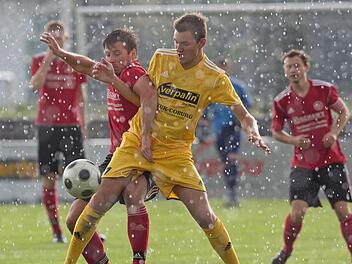 Der Eichaer Manuel Frembs (rechts) wehrt sich bei starkem Regen im Karl-Fleschutz-Stadion vehement gegen den Lichtenfelser Pascal Graf. Foto: Uwe Gick