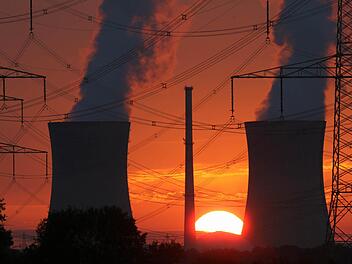 Sonnenuntergang hinter den Kühltürmen des Atomkraftwerks Grafenrheinfeld. Foto: Daniel Karmann/dpa
