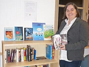 Bürgermeisterin Sonja Reubelt hat ein offenes Bücherregal im Rathaus angeschafft, bei dem sich und das jeder bedienen kann.  Foto: Marion Eckert