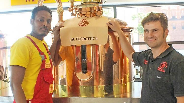 Ausbilder, Braumeister Constantin Förtner (rechts), zeigt Bisrat Tsegay in der kleinen Braumanufaktur den Läuterbottich Foto: Antonia Wild
