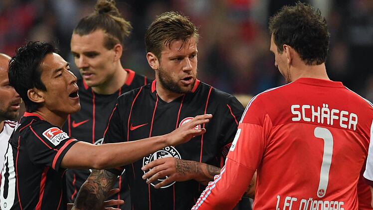 Im vergangenen Jahr standen sich der 1. FC Nürnberg (2. Liga) und Eintracht Frankfurt (1. Liga) gegenüber. In dieser Szene des Hinspiels diskutieren die Frankfurter Spieler Makoto Hasebe, Alex Meier und Marco Russ mit Nürnbergs Keeper Raphael Schäfer (von links nach rechts). Foto: Arne Dedert/dpa