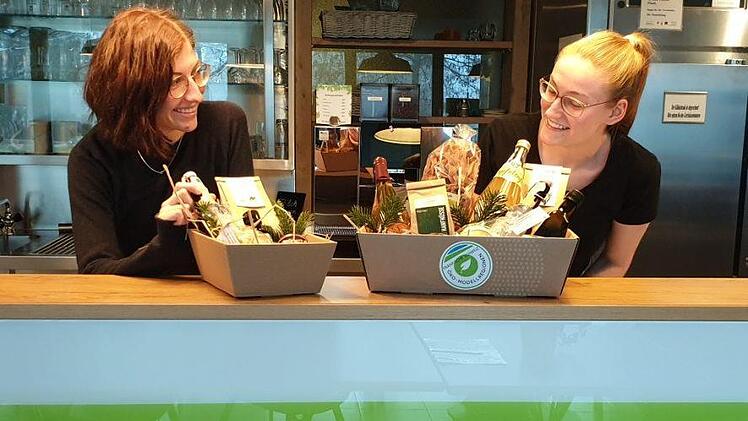 Die Kisten sind gestaltet und vorbereitet, wie Pia Keller (l.) und Christina Mark (Koordinatorin für Bio-Gemeinschaftsverpflegung) zeigen. Foto: PR
