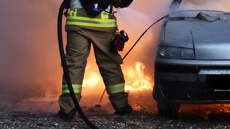 Fahrzeugbrand, Autobrand, brennendes Auto, Feuerwehr l&ouml;scht Flammen