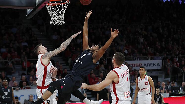 Im Schlussviertel gab es keine einfachen Punkte mehr für die Bonner. Hier liegt der Ex-Bamberger Ryan Thompson (Mitte) im Duell mit Daniel Theis (l.) und Fabien Causeur quer in der Luft. Foto: Daniel Löb