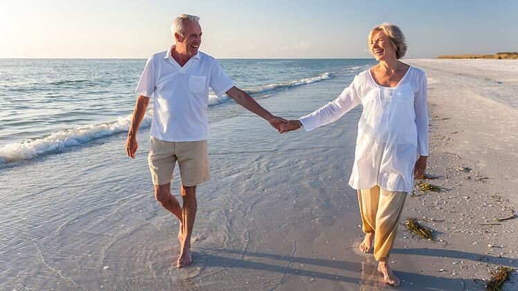 Happy Senior Couple Walking Holding Hands Tropical Beach