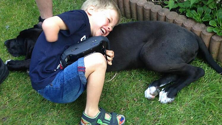 Luca spielt mit dem Hund von Bekannten. Doch der Junge aus Trailsdorf wünscht sich nichts sehnlicher als einen eigenen Hund.  Foto: Michaela Geisel