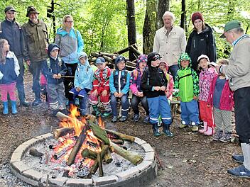Am Lagerfeuer vor Berndt Newigers Jagdhütte endete für die Kinder der Waldkindertag, die sich nach dem über zweistündigen Marsch dort gern aufwärmten. Günter Theinert (rechts) erzählte die Geschichte des untergegangenen Dorfes Stündingshausen. Foto: Dieter Britz