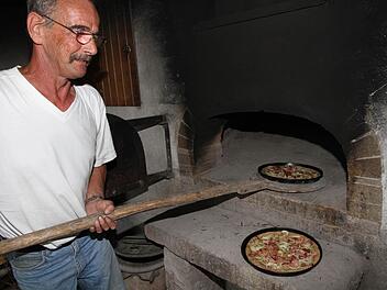 Die Aufgabe von Engelbert Mirsberger war es, die Zwiebelkuchen im Holzbackofen fertig zu machen. Foto: Erlwein