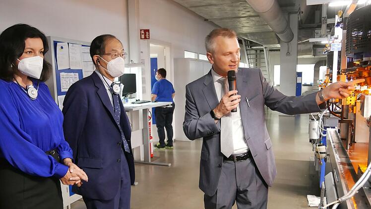 Nipro-Manager Markus Maßmann (rechts) erläutert dem japanischen Botschafter Yanagi Hidenao und Staatsministerin Dorothee Bär einen Fertigungsschritt bei der Herstellung pharmazeutischen Glases. Foto: Heike Beudert