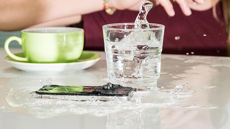 Unfreiwillige Dusche? Sollte Wasser in das Smartphone eindringen, hilft vor allem eines: Schnelligkeit: Mit ein paar Handgriffen k&ouml;nnen Nutzer versuchen. Schlimmeres zu vermeiden. Foto: Franziska Gabbert, dpa