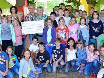 Die Schüler der vierten Klassen der Grundschule Reitsch überreichen an Evi und Günther Scheler 1800 Euro. Mit im Bild hinten von links, Rektorin Astrid Kestel, Elternbeiratsvorsitzende Sandra Lauterbach-Renk, Christina Reuther, Günther und Evi Scheler.  Foto: K.- H. Hofmann