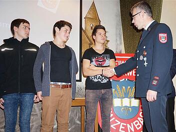 Mit dem traditionellen Handschlag begrüßte Kommandant Holger Amend (rechts) die Neuen bei der Waizenbacher Wehr (von links): Kevin Ullrich, Jannis Fürsch und Luca Biemüller. Foto: Gerd Schaar