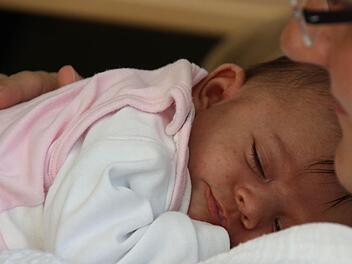 Satt und zufrieden: So schlummert die knapp fünf Wochen alte Lina im Arm ihrer Mama.
