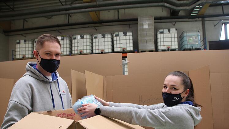 Auch die Schumacher-Auszubildenden Kevin Wige und Kristin Klimm sortieren die Spenden und verpacken sie in große Kartons.
