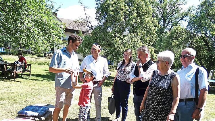 Gartenbesitzer Lukas Gieger zeigt Bürgermeister Alexander Wunderlich, Kreisfachberaterin Anna-Lena Neubig, Landrat Klaus Peter Söllner, Vorsitzender Margitte Kastner und Kreisvorsitzendem Günter Reif (von links) den Mehrgenerationengarten.