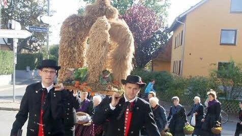 Die Erntekrone wird von den Mitgliedern im Verein erstellt und in die Kirche gebracht - in diesem Fall von den Trachtenträgern.