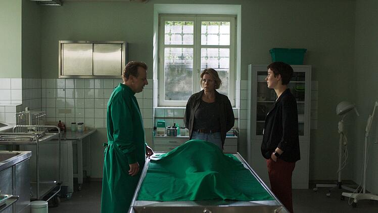 Gerichtsmediziner Gregor Eisen (Ronald Kukulies) informiert Chiara Locatelli (Maria W&ouml;rdemann, rechts) und Doro Beitinger (Franziska Weisz) &uuml;ber seine neuen Erkenntnisse zur Toten.