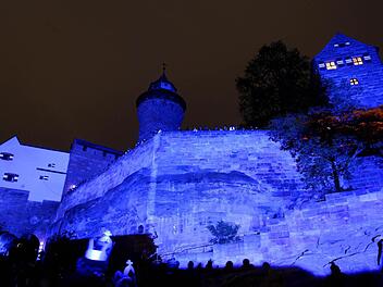 Am Samstag ist Nürnberg wieder blau, wie hier die Projektionen an der Kaiserburg. Foto: Daniel Karmann/dpa
