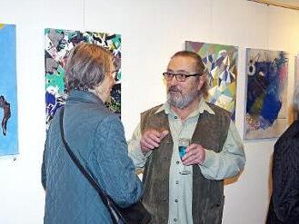 Christian Ianza im Gespräch mit Ausstellungsbesuchern. Im Hintergrund einige der 44 Exponate Foto: Heike Schülein