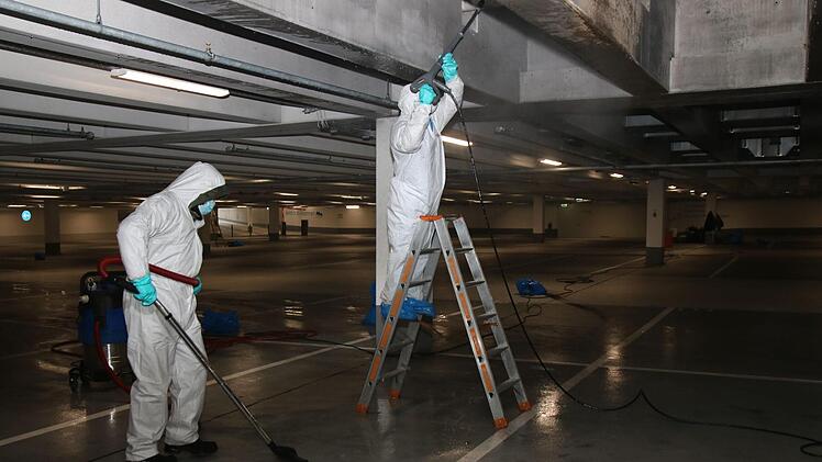 Mit dem Dampfstrahler werden die Rußflecken in der Tiefgarage beseitigt. Die eigentliche Brandsanierung läuft jetzt an. Foto: Alexander Hartmann