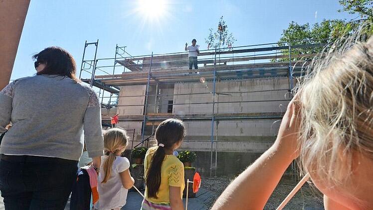 Bei stahlendem Sonnenschein wurde im Hallstadter Zentrum Richtfest gefeiert. Der Neubau ist mit einem denkmalgeschützen Bauernhaus verbunden. Foto: Ronald Rinklef