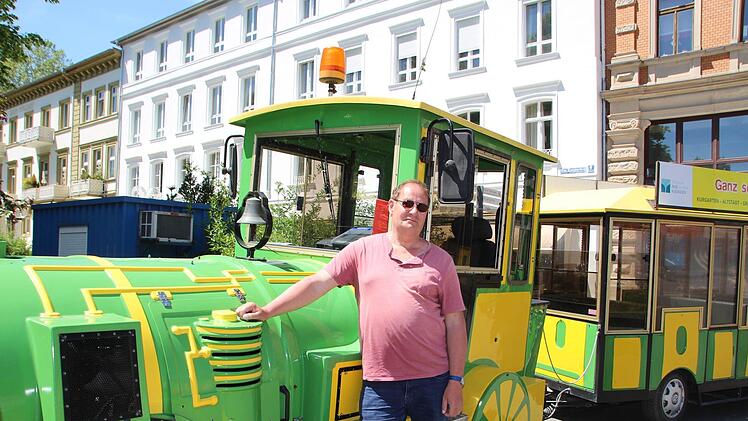 Fahrer Gunter Repp posiert während einer kurzen Pause vor der Lok. Die Geckobahn hält am Rondell vor dem Kurgarten. Foto: Charlotte Wittnebel-Schmitz