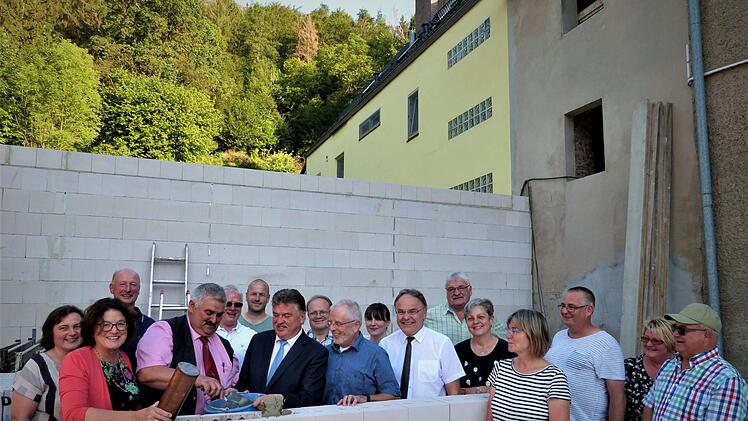 Zweiter  Bürgermeister Karl Opel und Landrat Klaus Peter Söllner vollzogen die Grundsteinlegung fürs Bürgerzentrum.  An der Mauer (von links) Regierungsdirektorin Marion Resch-Heckel,  Opel und  Söllner,  Architekt Hans-Hermann Drenske und Pfarrer Peter Brünnhäußer.W. Reißaus
