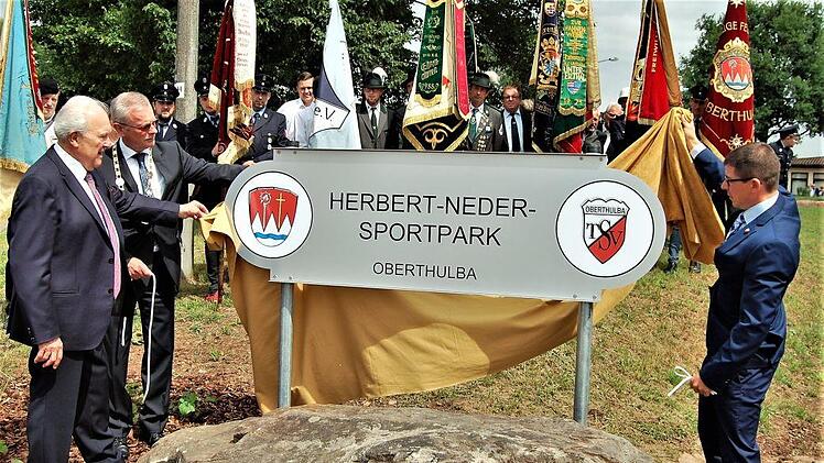Schirmherr und Altbürgermeister Gerhard Adam (von links), der heutige Bürgermeister Gotthard Schlereth und TSV-Vorsitzender Matthias Hüttl enthüllen das neue Namensschild. Foto: Sigismund von Dobschütz