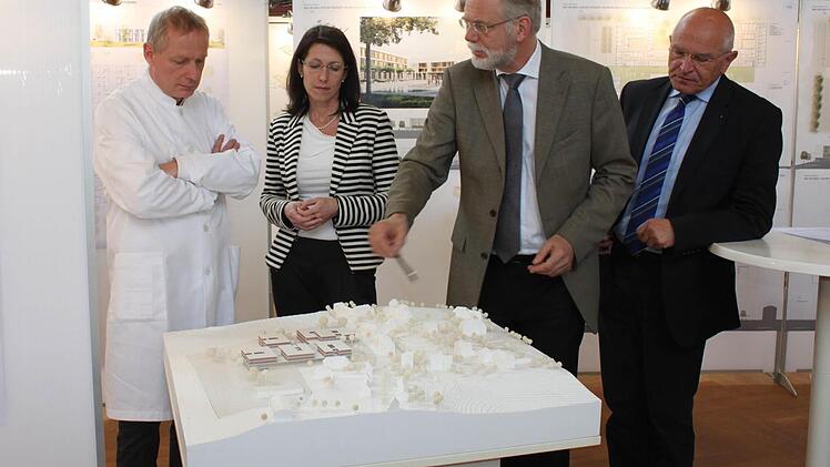 Ärztlicher Direktor Christoph Sommer, Katja Bittner (Vorstand), Wolfgang Großmann vom Planungsbüro für den Wettbewerb und Bezirkstagspräsident Günther Denzler (v.l.) sprechen über den Sieger-Entwurf.