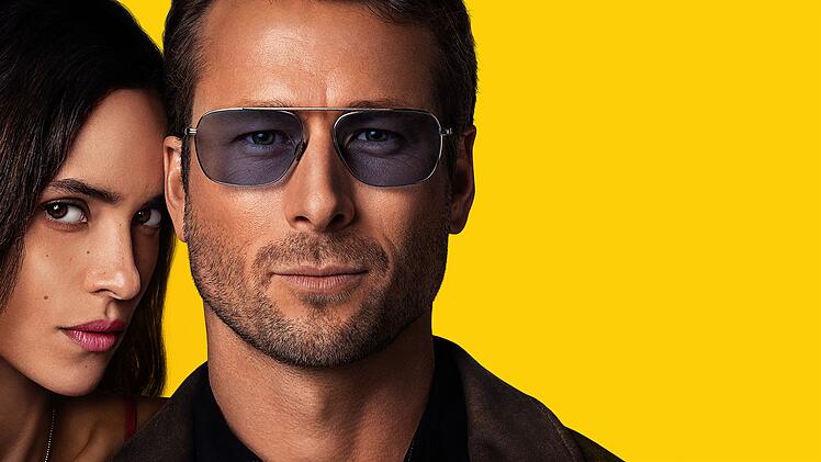 Gary (Glen Powell) entwickelt ein nicht immer professionell distanziertes Verh&auml;ltnis zu Madison (Adria Arjona), deren Pl&auml;ne er als Aushilfspolizist eigentlich &uuml;berwachen sollt.