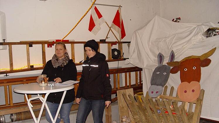 Vor der Krippe lasen Marion Breitenbach (links) und Nicola Kretz die Geschichte des kleinen Tims.  Foto: Brigitta Kempe-Wolf