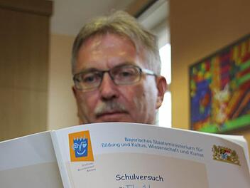 Schulrat Uwe Dörfer ist selbst gespannt, wie manche Neuerungen angenommen werden. Hier blättert er gerade im Konzept für das Projekt "Flexible Grundschule". Foto: Marco Meißner
