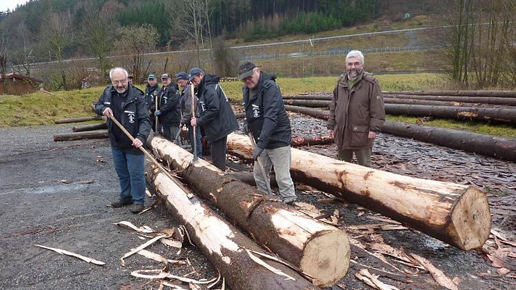An der Neuseser Zollschere mussten die Fichtenstämme für den Floßbau mit der Hand geschält werden. Mit dabei waren Vorsitzender Edgar Dunst, Fred Blinzler, Fritz Schedel, Herbert Schedel, Karlheinz Ullmann, Egon Zwack und Michael Schmidt. Mit im Bild auch Forstbetriebsleiter Peter Hagemann. Foto: Gerd Fleischmann