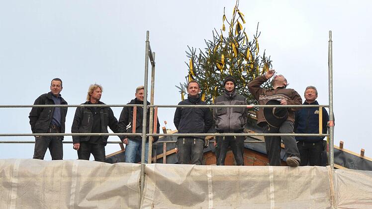 Zimmerermeister Hans Stübinger (zweiter von rechts) leert nach getanem Aufrichtspruch für die künftige "Kultur.Werk.Stadt" das Glas, um es dann am Boden zu zerschmettern. Fotos: Rainer Lutz
