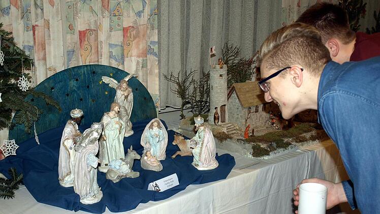 Auch die Jugend ist von den Krippenfiguren fasziniert. Foto: Susanne Deuerling