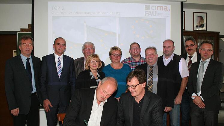 Höchstadts Bürgermeister Gerald Brehm (l.) unterzeichnete als erster den Vertrag. Vom Experten- und Beratungsteam unterschrieb Michael Seidel. Foto: Evi Seeger