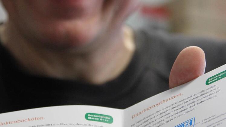 Energieberater Günther Liebert zeigt ein Heftchen der Deutschen Energie-Agentur, das dem Kunden die Energieeffizienz-Skala näher erläutern soll. Die Sache ist komplizierter als gedacht.