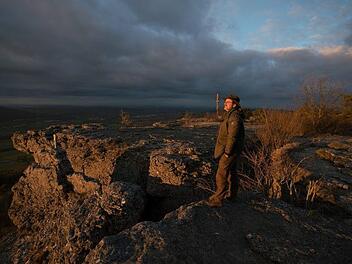 Ein Moment der Ruhe: Nicht immer muss der Blick durch den Sucher gehen. Naturfotograf Stefan Friedrich weiß, seine Kamera auch mal zum passenden Zeitpunkt zur Seite zu legen. Etwa, um wie hier den Blick vom Staffelberg zu genießen. Foto: Stefan Friedrich