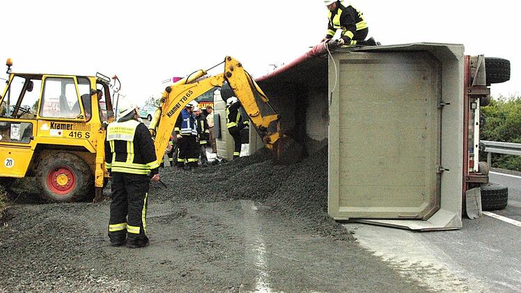 Genau auf der Verbindungsspange zwischen der Bundesstraße 303 und der Staatsstraße Hofheim/Rügheim ist der Sattelzug umgekippt. 26 Tonnen Mineralbeton rutschten auf die Fahrbahn und in den Graben. Die Feuerwehr half bei der Bergung und den Aufräumarbeiten.  Foto: gsch