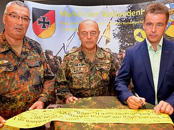 Für die Marktgemeinde Bad Bocklet unterschrieb Kurdirektor Thomas Beck das gelbe Band, das einer Einheit mit auf den Weg in einen Auslandseinsatz gegeben wird (von links: Hauptfeldwebel d.R. Manfred Stange, Oberstleutnant d.R. Johann Schmidt, die beide im Landesvorstand der Bundeswehrreservisten tätig sind, und Kurdirektor Thomas Beck).