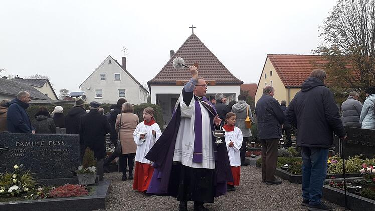 In Lettenreuth besprengte Pfarrer Rebhan die Gräber mit Weihwasser. Foto: Horst Habermann